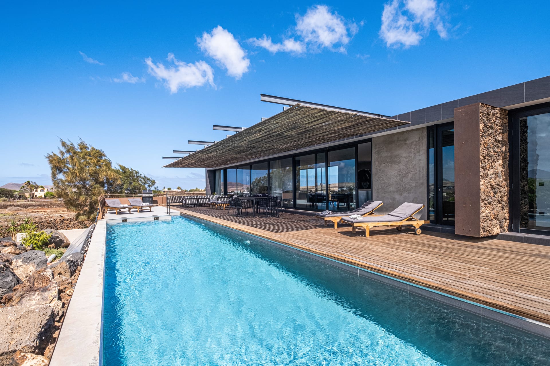 Luxurious interior with volcanic stone walls and ocean view